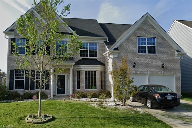 4430 Saddlewood Club Dr, High Point, NC 27265 - view of front of home with brick siding, a front lawn, an attached garage, and concrete driveway