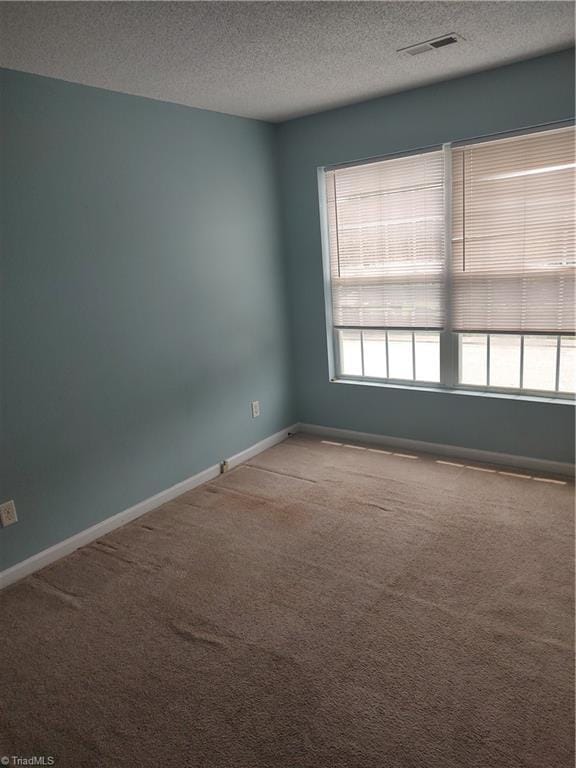 3855 Windstream Way, Jamestown, NC 27282 - carpeted spare room featuring a textured ceiling and baseboards