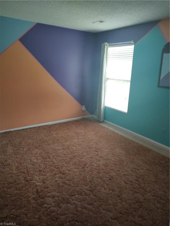 3855 Windstream Way, Jamestown, NC 27282 - carpeted empty room with a textured ceiling and baseboards