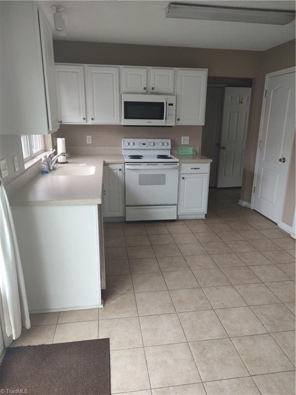 3855 Windstream Way, Jamestown, NC 27282 - kitchen with white appliances, a sink, light countertops, white cabinets, and light tile patterned floors