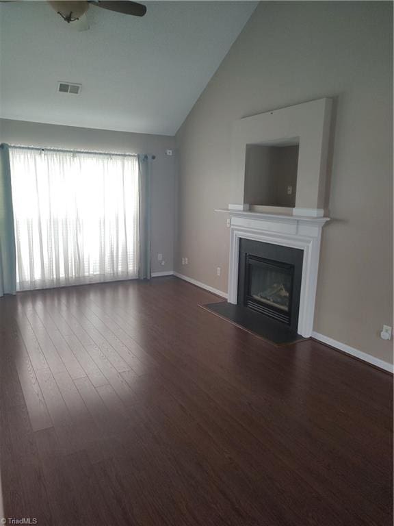 3855 Windstream Way, Jamestown, NC 27282 - unfurnished living room featuring wood finished floors, ceiling fan, a fireplace with flush hearth, baseboards, and high vaulted ceiling