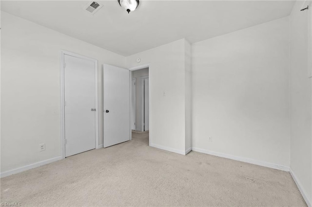unfurnished bedroom featuring baseboards, carpet flooring, and visible vents
