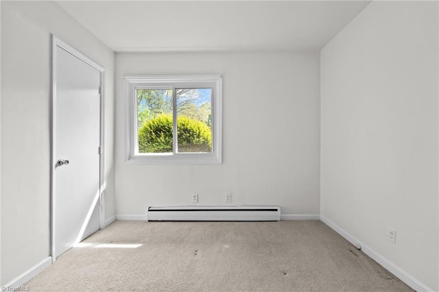 carpeted spare room with a baseboard heating unit and baseboards