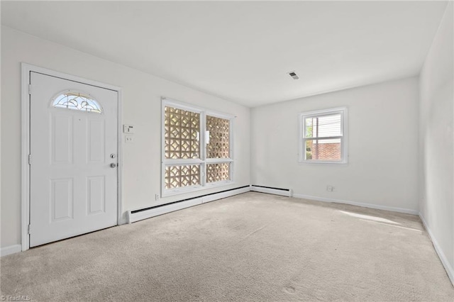 entrance foyer featuring visible vents, baseboards, light carpet, and baseboard heating