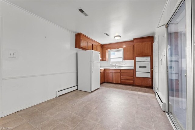 kitchen with baseboard heating, a warming drawer, a sink, and white appliances