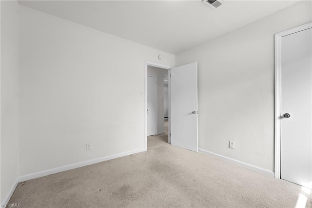 unfurnished bedroom with carpet floors, visible vents, and baseboards