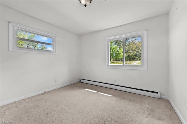 unfurnished room featuring baseboard heating, baseboards, and carpet