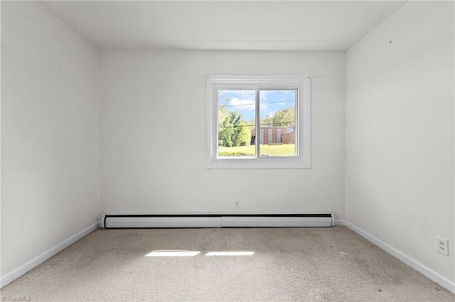 carpeted spare room featuring baseboards and a baseboard radiator
