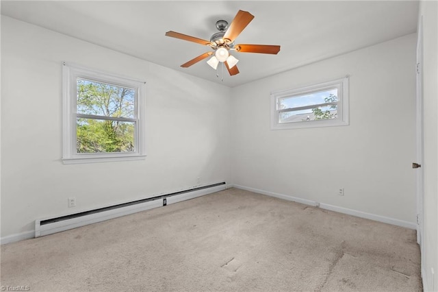 empty room featuring baseboard heating, a wealth of natural light, and carpet floors