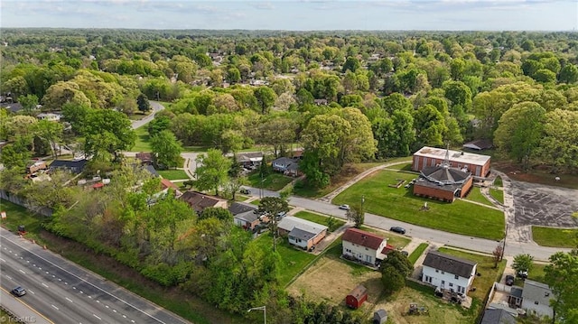 drone / aerial view featuring a wooded view
