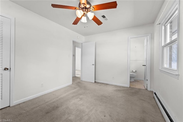unfurnished bedroom with baseboard heating, visible vents, carpet floors, and connected bathroom