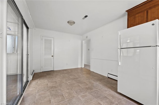 interior space with visible vents, baseboard heating, freestanding refrigerator, and crown molding