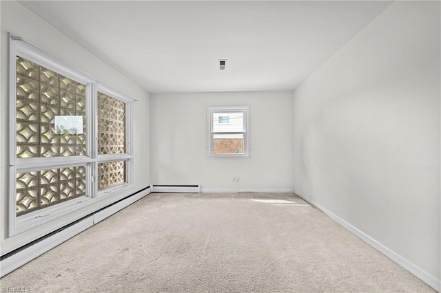 carpeted empty room with visible vents, baseboard heating, and baseboards