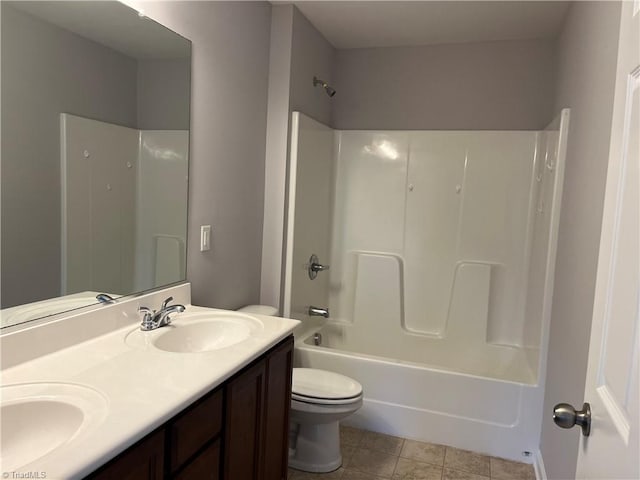 bathroom featuring a sink, shower / bathing tub combination, toilet, and double vanity