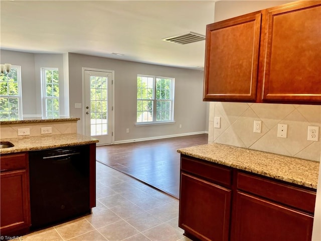 kitchen with visible vents, decorative backsplash, open floor plan, black dishwasher, and light stone counters