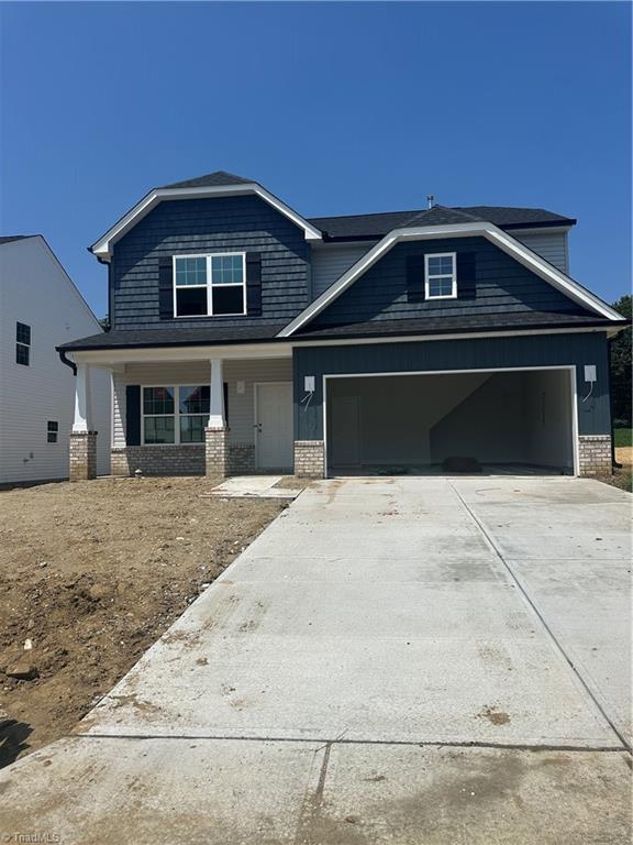 3293 Alyssa Way Lot 3, High Point, NC 27265 - craftsman-style house with concrete driveway, covered porch, an attached garage, and brick siding