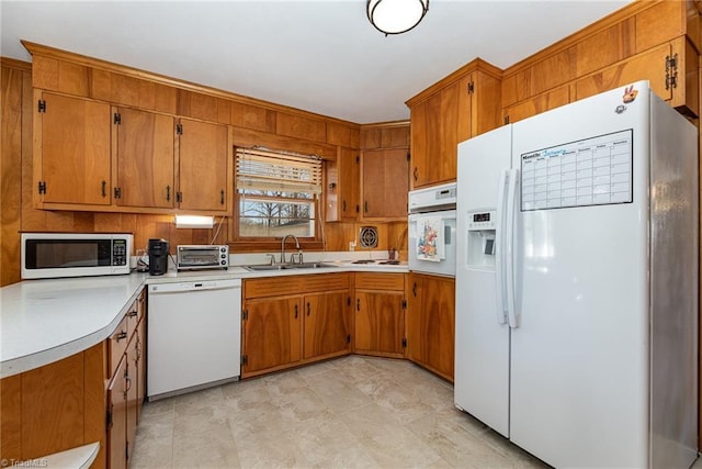 kitchen featuring sink and white appliances