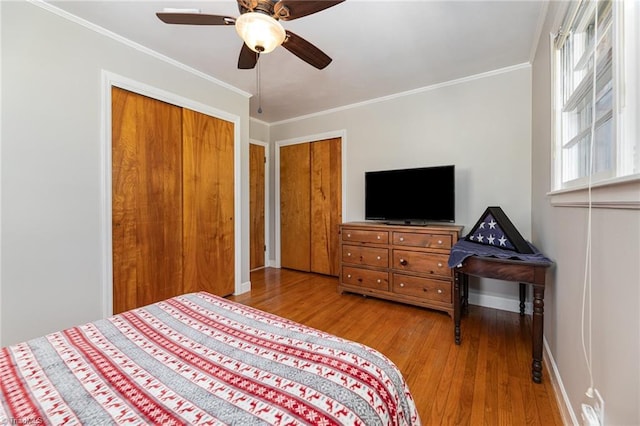 bedroom with light wood-type flooring, ceiling fan, and crown molding