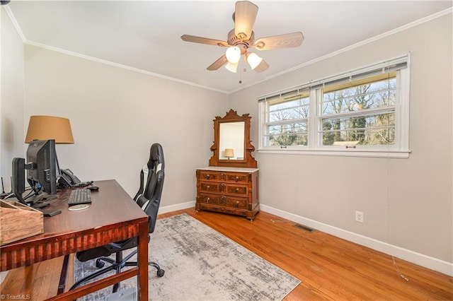 office featuring ceiling fan, hardwood / wood-style flooring, and crown molding