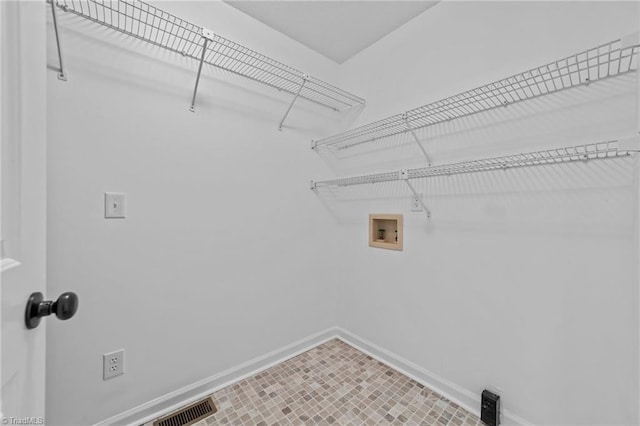 washroom featuring washer hookup, visible vents, baseboards, and laundry area