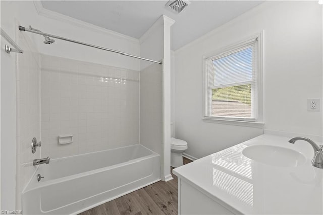 bathroom with wood finished floors, visible vents, toilet, and ornamental molding