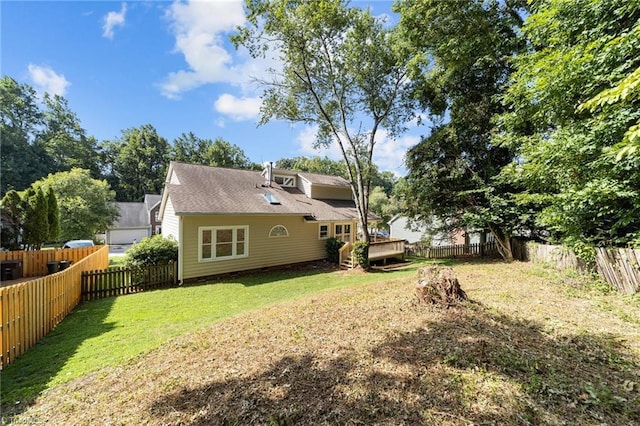 view of yard with a wooden deck and a fenced backyard
