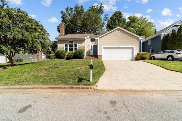view of front of house with a chimney, a front lawn, driveway, and a garage
