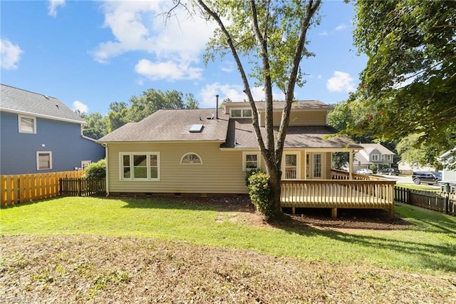 rear view of property with crawl space, a fenced backyard, a yard, and a deck