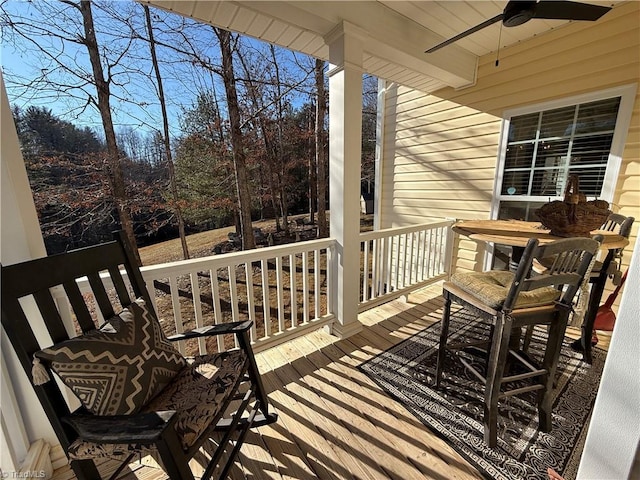 wooden deck with a ceiling fan