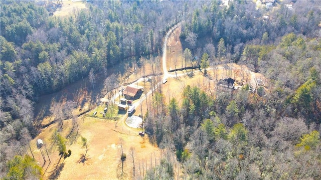 birds eye view of property with a view of trees