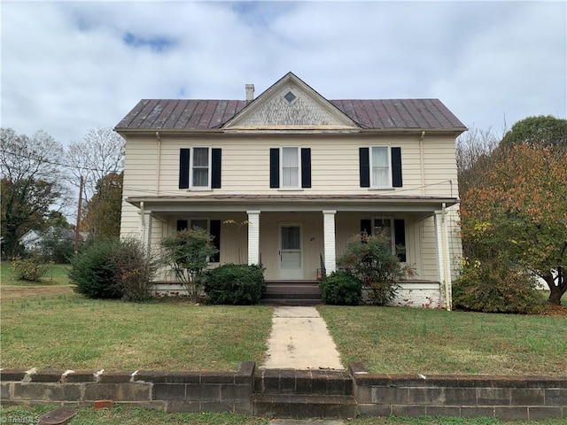 view of front of house featuring a front yard and covered porch