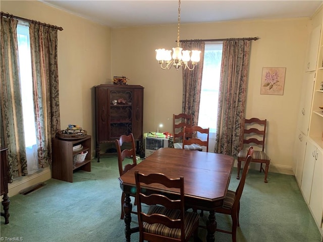 carpeted dining room featuring an inviting chandelier