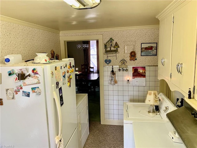 clothes washing area featuring tile walls, washer / dryer, and crown molding