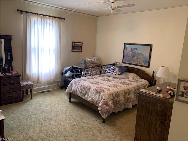 bedroom with ceiling fan, multiple windows, and carpet