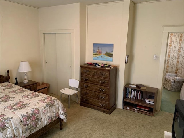 bedroom with a closet and light colored carpet