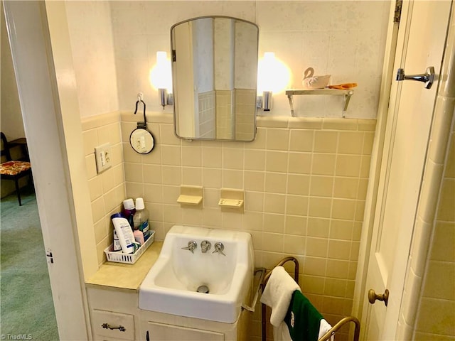 bathroom featuring tile walls and sink