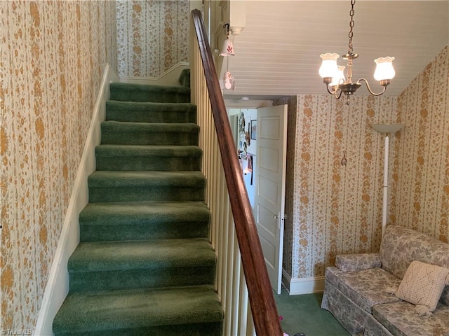 staircase with carpet and an inviting chandelier