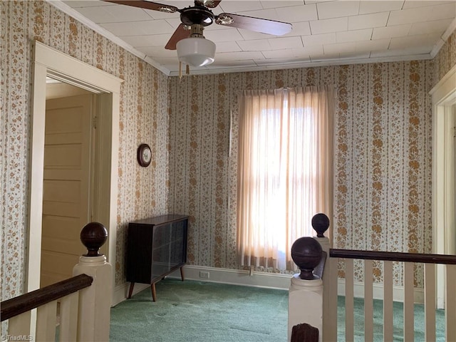 unfurnished bedroom featuring ornamental molding, carpet, multiple windows, and ceiling fan