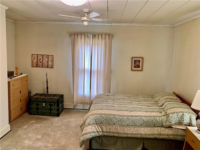 bedroom featuring ceiling fan, light colored carpet, and ornamental molding