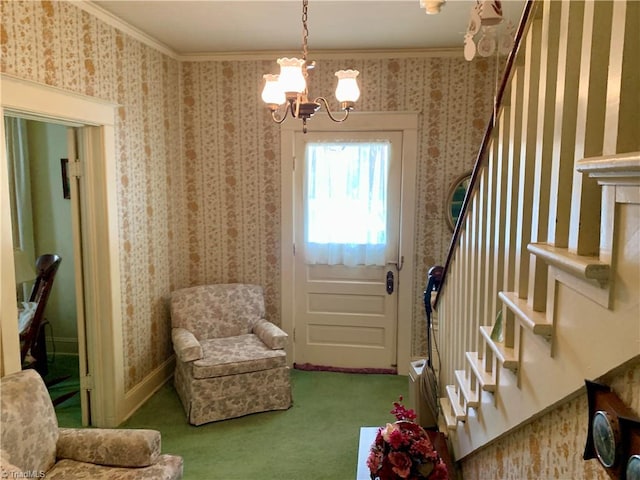 entrance foyer featuring carpet flooring, a notable chandelier, and crown molding