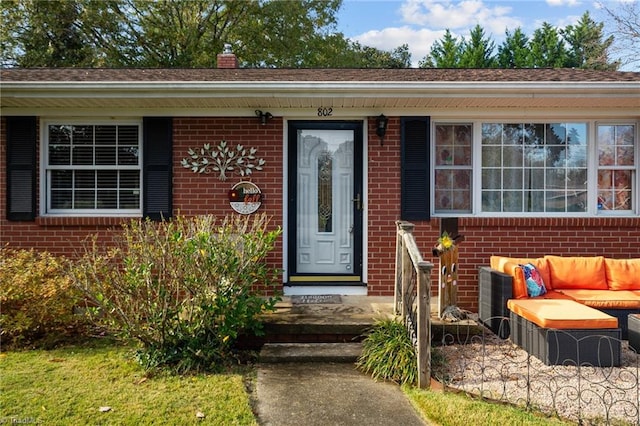 view of exterior entry with outdoor lounge area