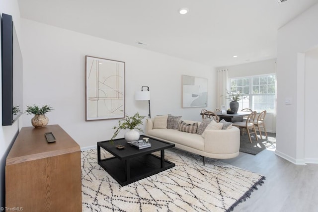 living room with light hardwood / wood-style flooring