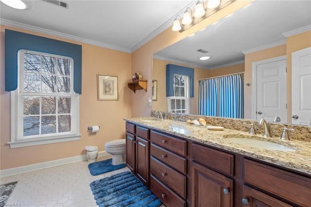 full bath featuring toilet, crown molding, and a sink