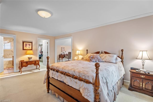 bedroom with crown molding, a closet, a walk in closet, and light colored carpet