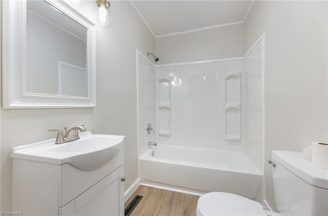 full bathroom featuring hardwood / wood-style flooring, vanity, toilet, and bathtub / shower combination