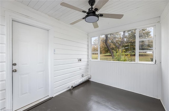 unfurnished sunroom with ceiling fan