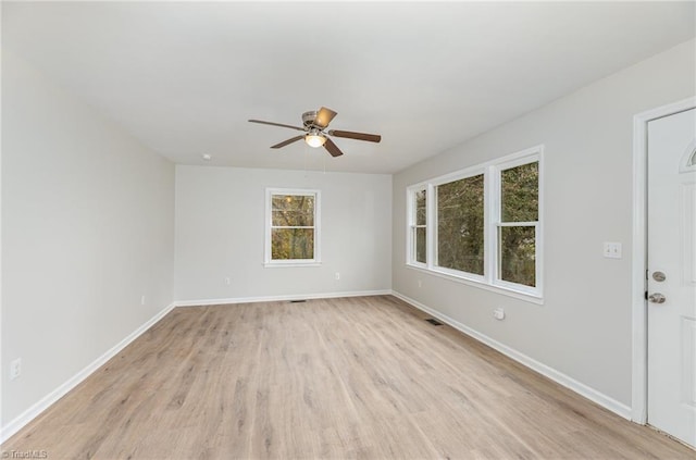 empty room with ceiling fan and light wood-type flooring