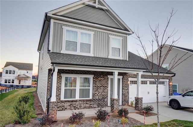 view of front of property featuring a front yard and a garage