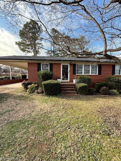 view of front facade with a front yard and a carport