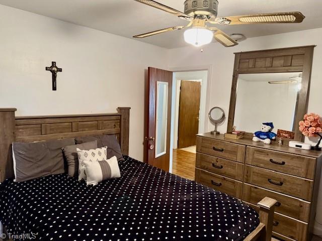 bedroom featuring hardwood / wood-style floors and ceiling fan